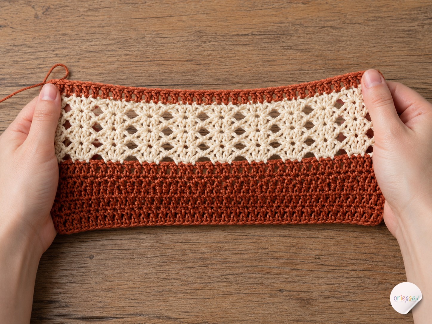 Close-up of hands working crochet lace stitches