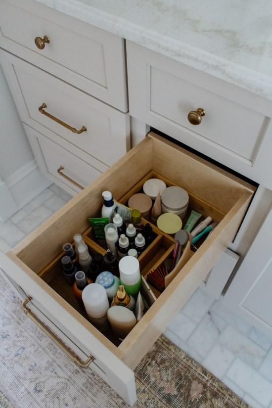 Vertical bottles organized in bathroom drawer