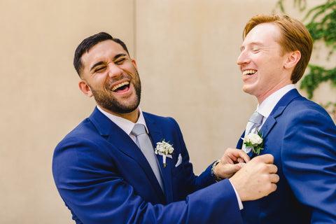 Best man and groom laughing