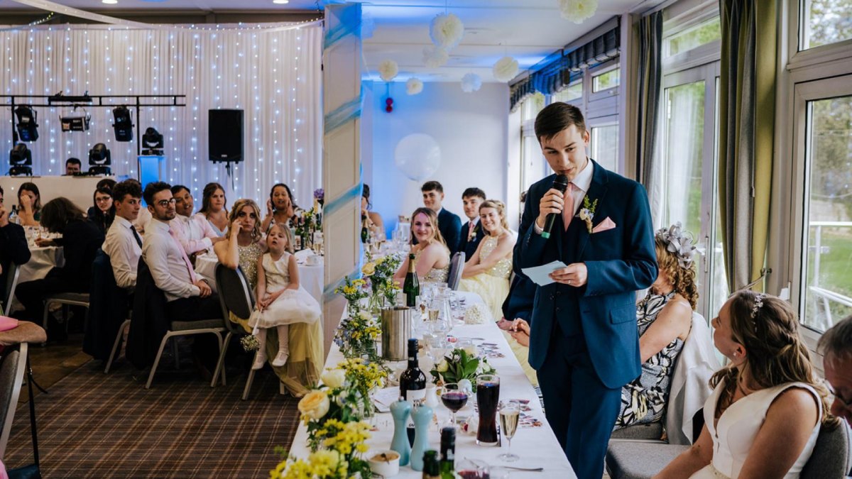 Guests listening to best man speech