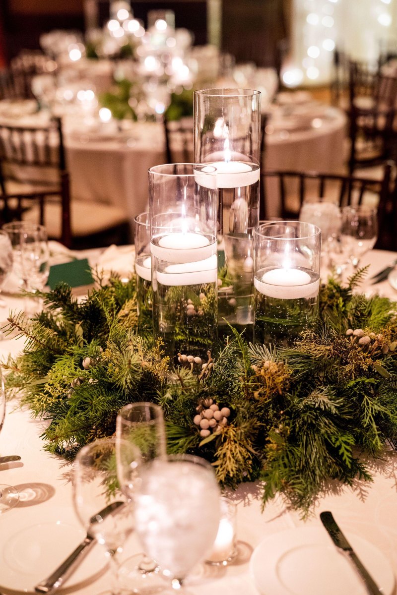 Evergreen candles winter wedding centerpiece