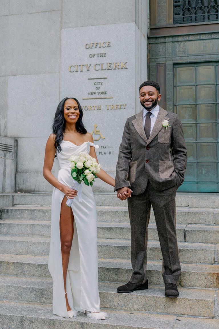 Couple posing outside city hall wedding