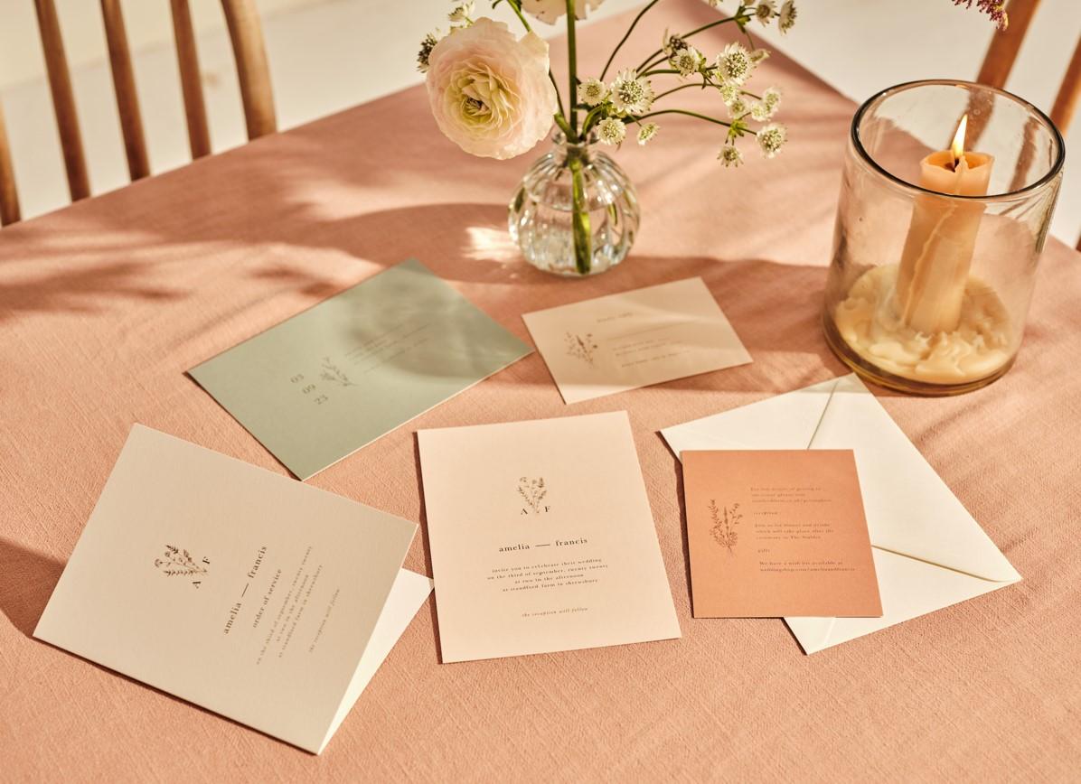 Elegant wedding invitations on table