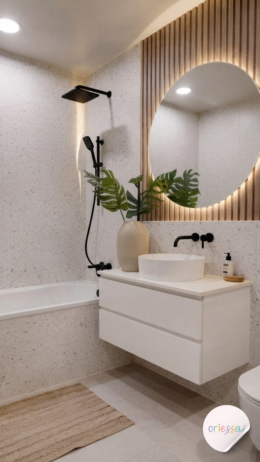 Amber glass soap pumps and dried lavender style a marble counter with brass for cozy bathroom decor.