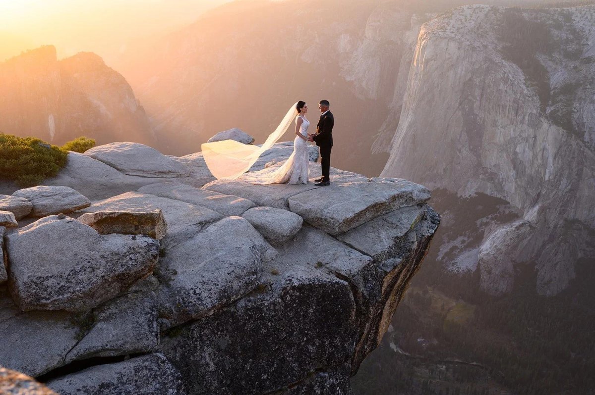 Eloping couple on dramatic cliffside landscape