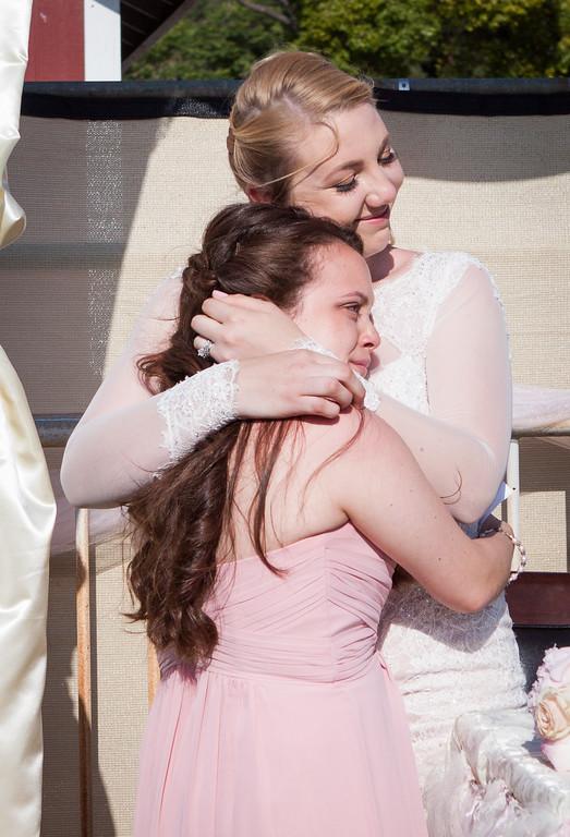 Sisters sharing emotional wedding moment
