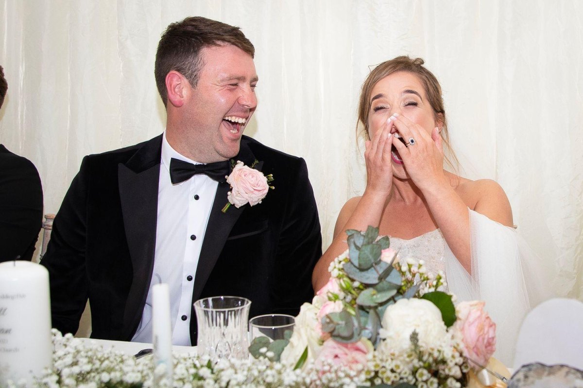 Couple laughing during wedding reception