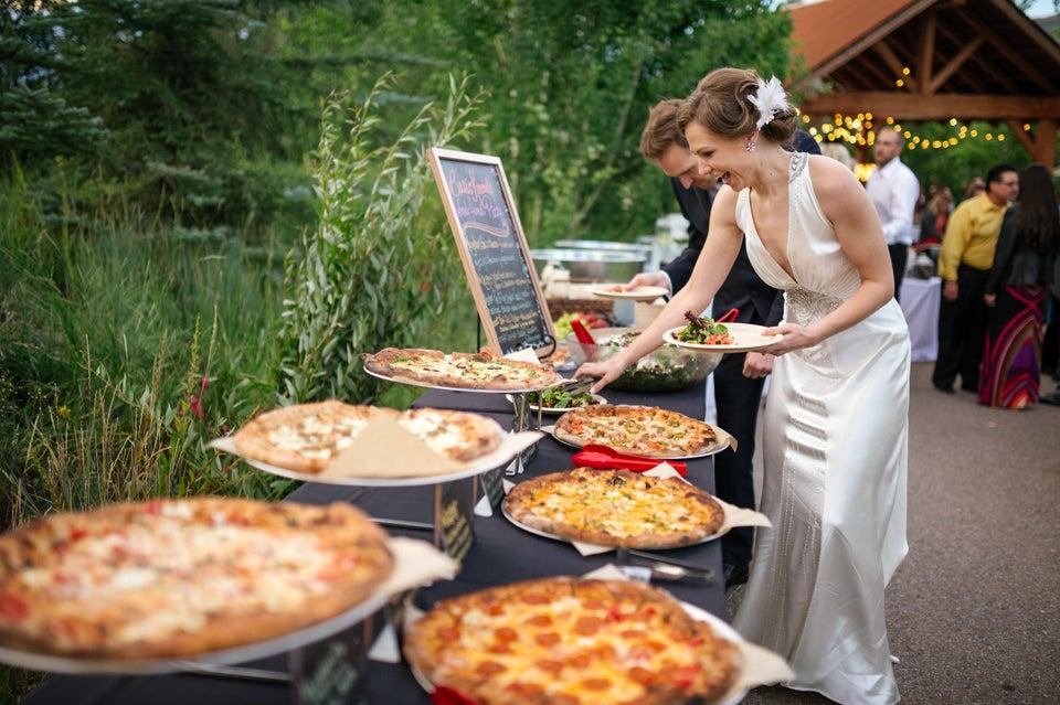Guests enjoying wedding pizza station