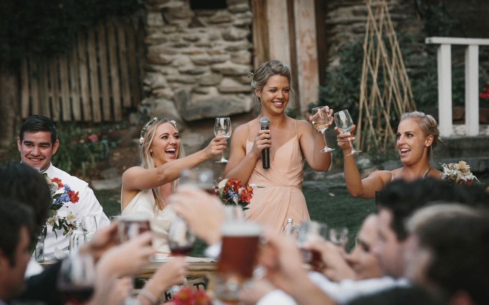 Maid of honor raising toast at wedding