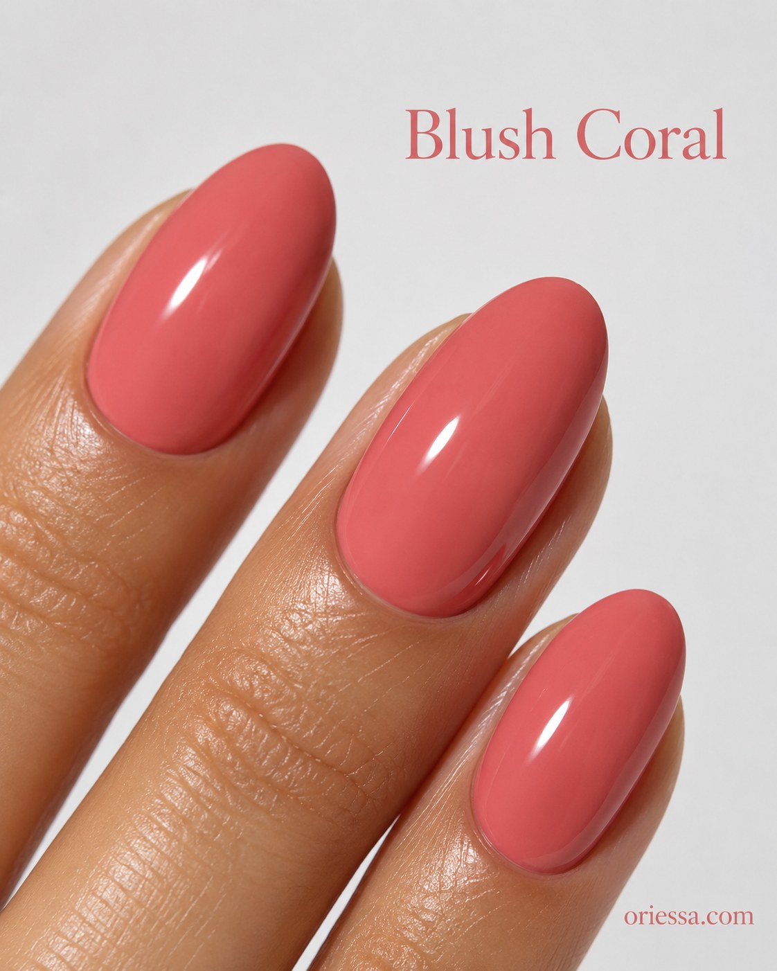 Blush coral nail color on oval nails, a soft everyday pick among nail colors for deep skin tones