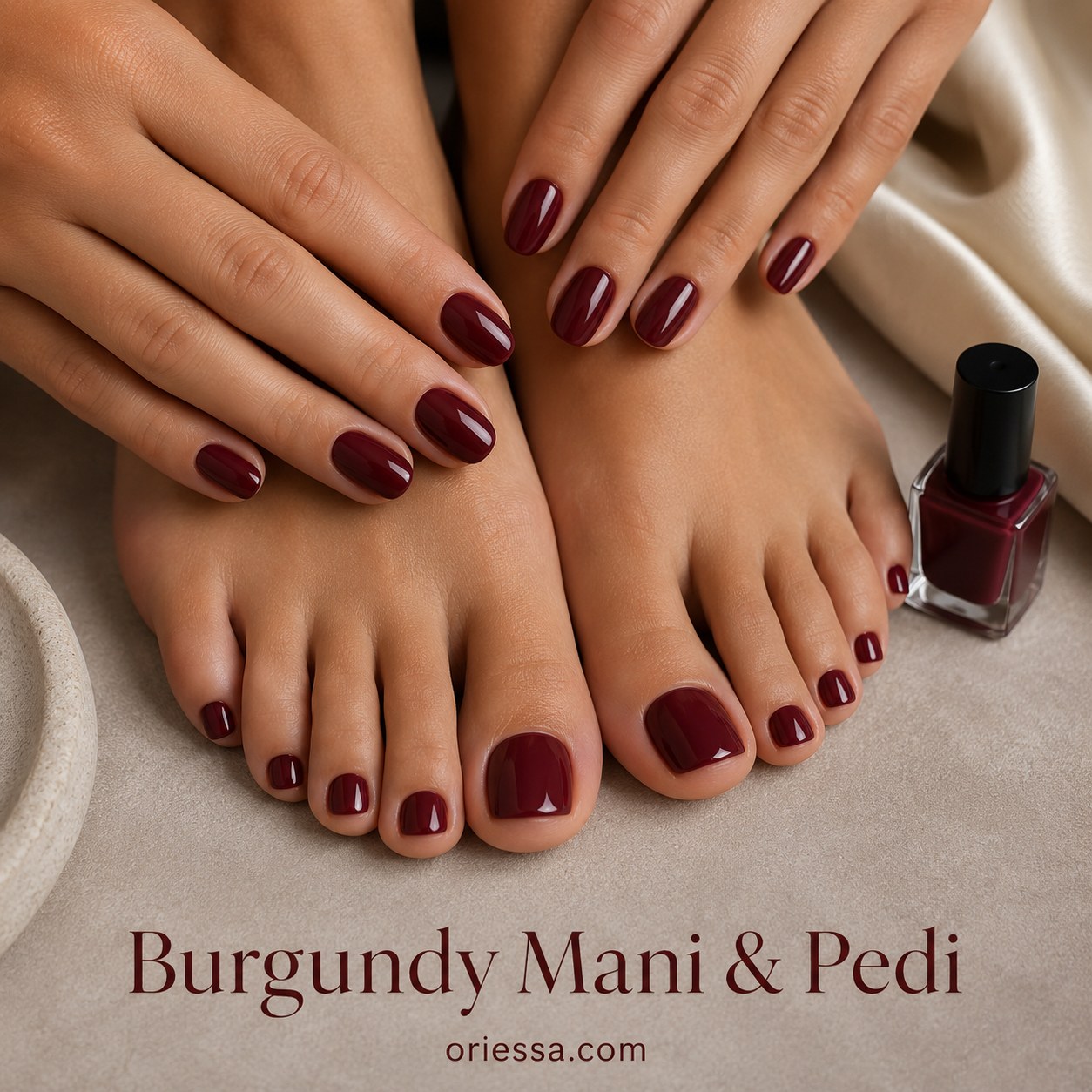 Burgundy mani and pedi set glowing on deep skin tones beside the matching burgundy polish bottle