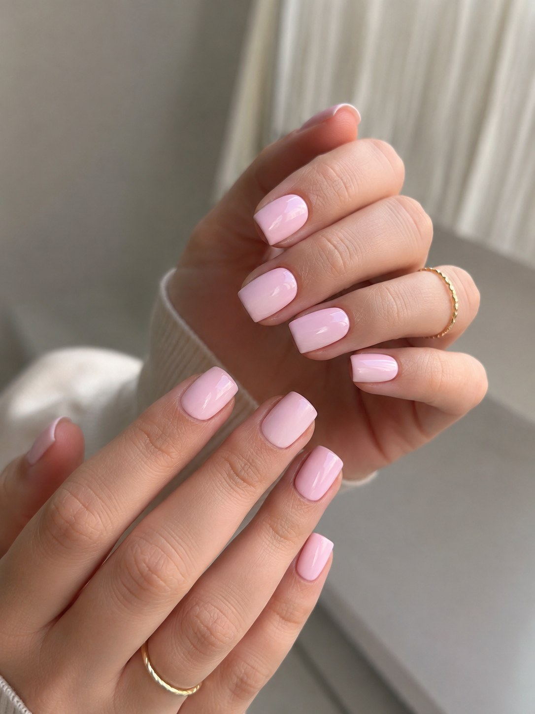 Short round pink nails in a solid milky shade, a low-maintenance coffin alternative