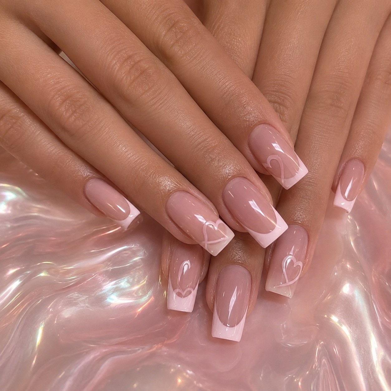 Square French tip nails with a soft heart line art accent over a holographic base