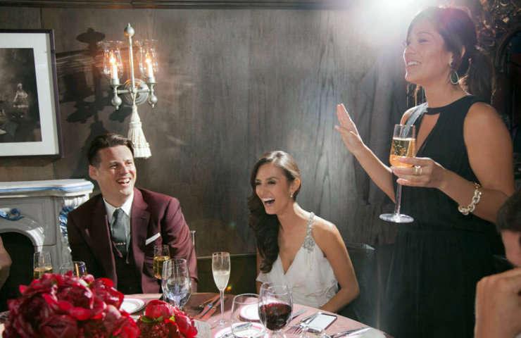 Wedding guests laughing during toast