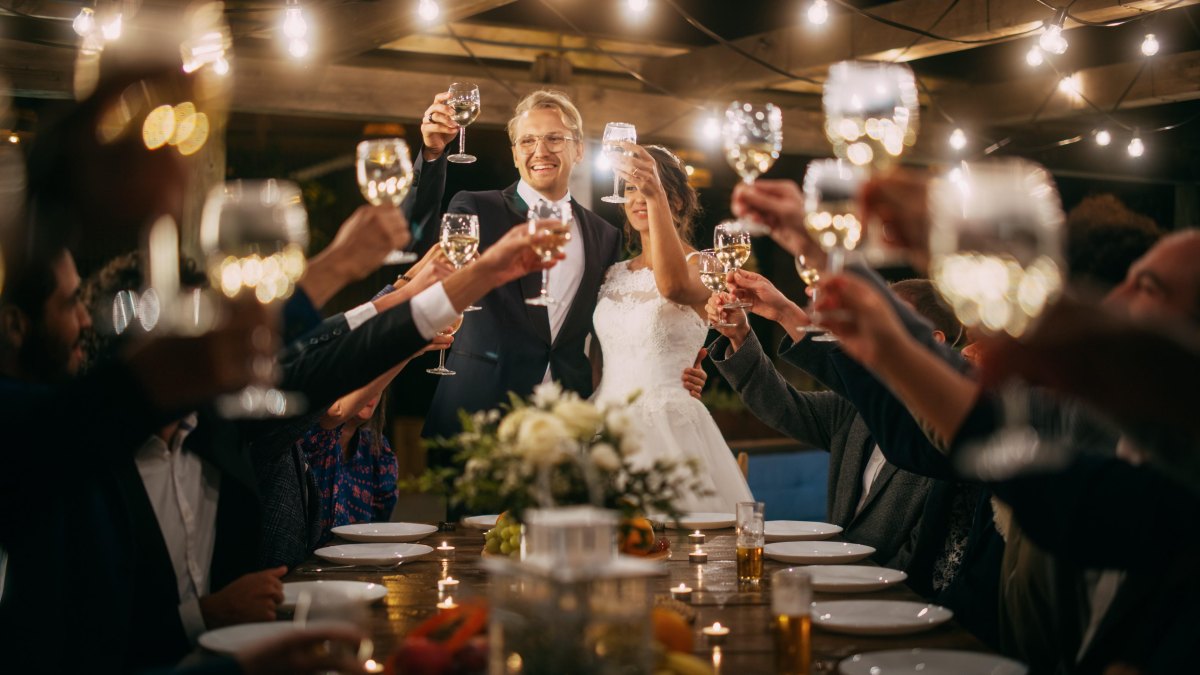 Guests raising glasses at wedding toast