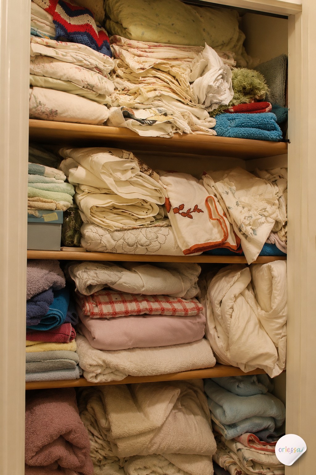 A hanging shelf-and-rod combo unit adds folded storage above an existing rod in a tight closet.