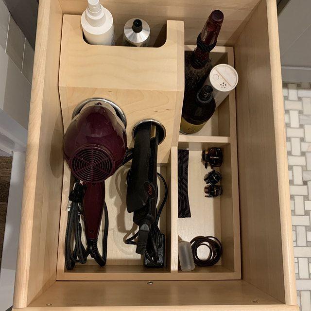 Hair tools stored in bathroom drawer containers