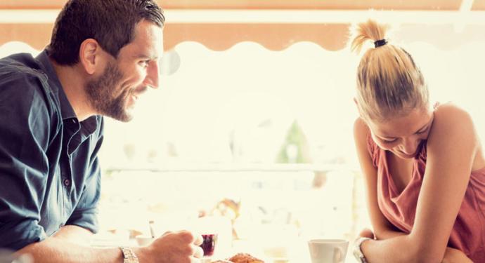 Couple meeting for first time at cafe