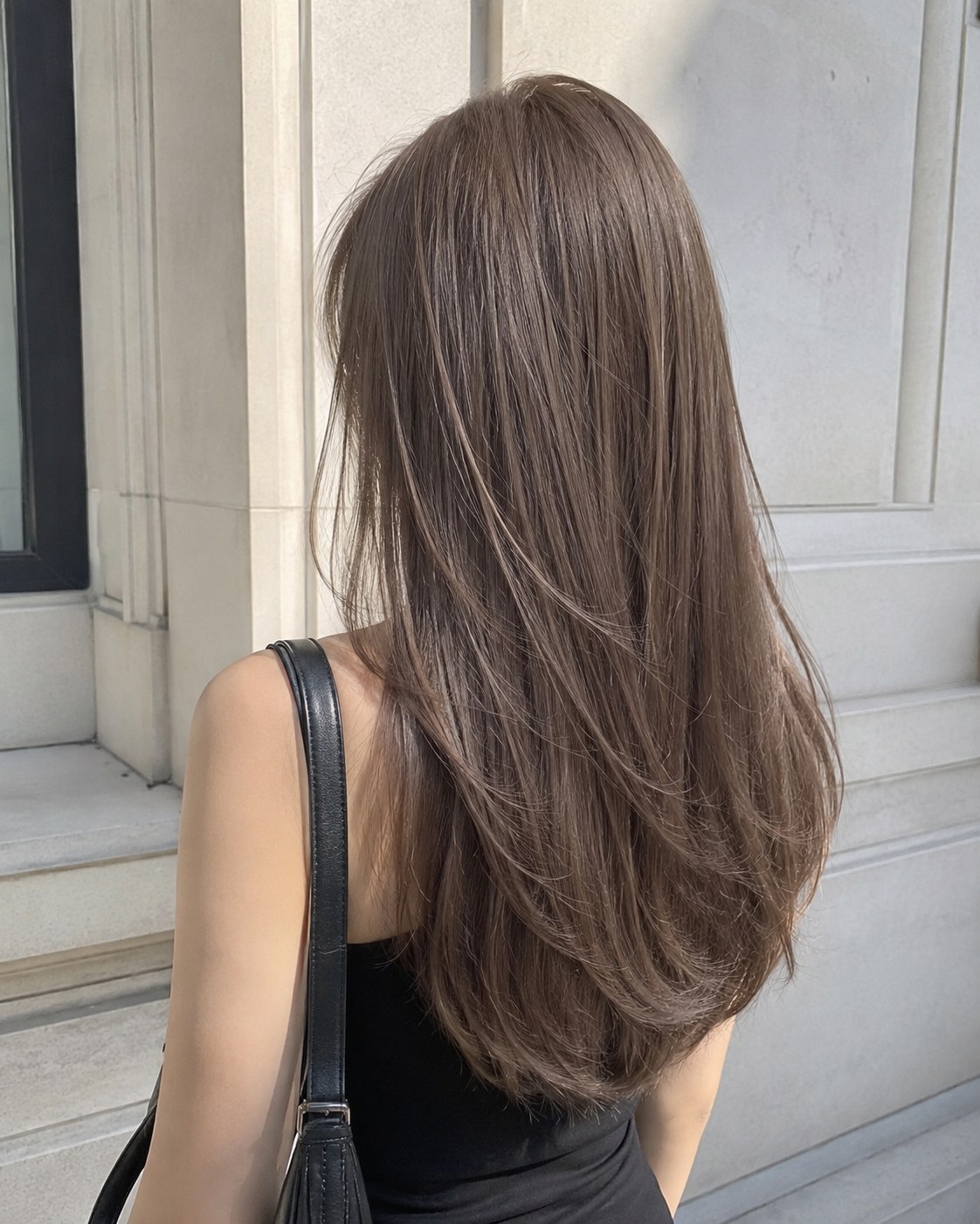 Side-back view of a face-framing cascade layered cut styled for extra volume on thin hair