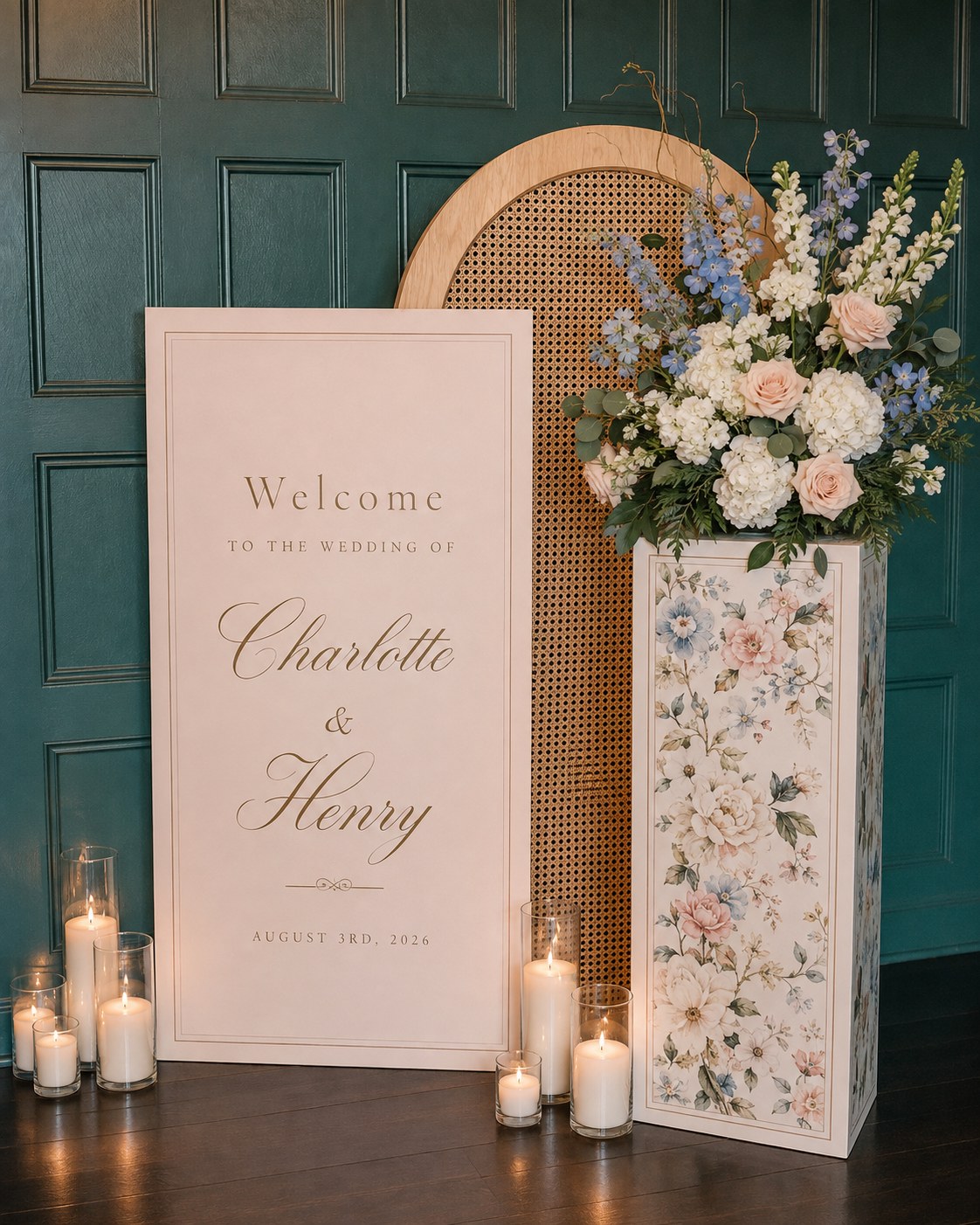 Wedding welcome sign styled beside a painted floral vase against a dark green paneled wall